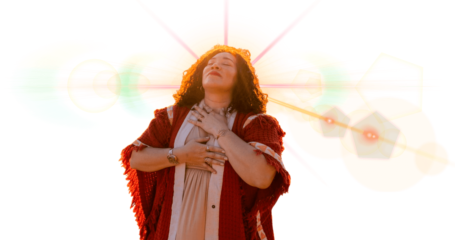 Elisha with hands on heart connecting to the energy inside herself. She has a spark of light shining out from behind her head.